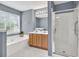 This bathroom features a shower, soaking tub, and double sink vanity at 1220 Skipping Rock Sw Ln, Grayson, GA 30017