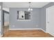 View of dining room featuring wood floors, a chandelier, and gray walls at 1220 Skipping Rock Sw Ln, Grayson, GA 30017