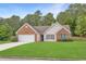 Charming one-story home with brick accents, a manicured lawn, and attached two-car garage at 1220 Skipping Rock Sw Ln, Grayson, GA 30017