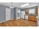 Bright kitchen featuring wood floors, gray walls, and appliances including a white refrigerator and dishwasher at 1220 Skipping Rock Sw Ln, Grayson, GA 30017