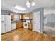 This well-lit kitchen features wood floors, wooden cabinetry, and white appliances at 1220 Skipping Rock Sw Ln, Grayson, GA 30017