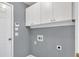 A gray laundry room with white cabinets, with a washer/dryer hookups at 1220 Skipping Rock Sw Ln, Grayson, GA 30017