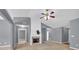 Bright living room includes a ceiling fan, fireplace, and multiple doorways at 1220 Skipping Rock Sw Ln, Grayson, GA 30017