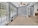 Bright living room with a ceiling fan, multiple windows, and a patio door at 1220 Skipping Rock Sw Ln, Grayson, GA 30017