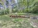A beautiful backyard is complete with landscaping and gardening tools at 2478 Roseberry Ln, Grayson, GA 30017