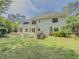 Spacious backyard featuring a patio, outdoor kitchen, and mature trees for shade at 2478 Roseberry Ln, Grayson, GA 30017