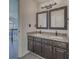 Bathroom features a double vanity with granite countertops, dark cabinets, and modern fixtures at 2478 Roseberry Ln, Grayson, GA 30017