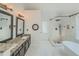 Bright, updated bathroom showcasing dual sinks, a soaking tub, a walk-in shower, and modern fixtures at 2478 Roseberry Ln, Grayson, GA 30017