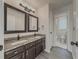 Bathroom boasts granite countertops, double sinks, modern fixtures, and convenient access to a tiled shower at 2478 Roseberry Ln, Grayson, GA 30017