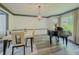 Dining room with luxury vinyl plank flooring and a grand piano next to a window at 2478 Roseberry Ln, Grayson, GA 30017