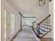 Bright foyer featuring luxury vinyl plank flooring and a staircase with rod iron spindles at 2478 Roseberry Ln, Grayson, GA 30017