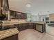 Well-equipped kitchen features stainless appliances, stone countertops, and dark wood cabinetry at 2478 Roseberry Ln, Grayson, GA 30017