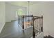 Bright landing area featuring decorative iron railing, modern lighting, and a large arched window at 2478 Roseberry Ln, Grayson, GA 30017