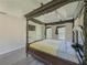 Bright main bedroom with a decorative four-poster bed, tray ceiling and views from two windows at 2478 Roseberry Ln, Grayson, GA 30017