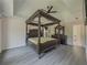 Spacious main bedroom features a four-poster bed, tray ceiling with fan, and ensuite bathroom access at 2478 Roseberry Ln, Grayson, GA 30017