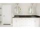 This bathroom features a double vanity with two mirrors, and a white door at 2484 Mcafee Rd, Decatur, GA 30032