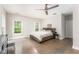 Bright bedroom with hardwood floors, fan and natural light from two windows at 2484 Mcafee Rd, Decatur, GA 30032