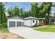 Charming home featuring a two-car garage, lovely landscaping, and a welcoming front porch area at 2484 Mcafee Rd, Decatur, GA 30032
