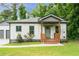 Charming renovated home with inviting front porch and well-manicured lawn and a 2-car garage at 2484 Mcafee Rd, Decatur, GA 30032