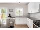 This kitchen features white cabinets, black countertops, and stainless steel appliances at 2484 Mcafee Rd, Decatur, GA 30032