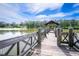 Scenic pier with a wooden pergola offering beautiful lake views and serene surroundings at 2484 Mcafee Rd, Decatur, GA 30032