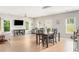 Spacious and bright living room features hardwood floors, and multiple windows overlooking backyard at 2484 Mcafee Rd, Decatur, GA 30032