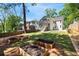 Backyard featuring plant beds ready for planting with a view of the home and outdoor stairwell to the second story at 2553 Creekwood Ter, Decatur, GA 30030