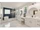 A spacious bathroom featuring dual vanities, soaking tub, and a separate glass enclosed shower at 2553 Creekwood Ter, Decatur, GA 30030