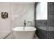 Close up of modern bath features a soaking tub with tile accent wall at 2553 Creekwood Ter, Decatur, GA 30030