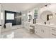 Modern bathroom with dual sinks, white cabinets, standalone tub, and stylish tile work at 2553 Creekwood Ter, Decatur, GA 30030