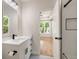 Bright bathroom featuring a single vanity, and a glass enclosed tiled shower at 2553 Creekwood Ter, Decatur, GA 30030