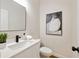 Well-lit powder room with a modern vanity, black faucet, elegant mirror and sleek, black accents at 2553 Creekwood Ter, Decatur, GA 30030