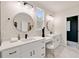 A bathroom with dual sink vanities with black hardware, modern lighting, and a make up station at 2553 Creekwood Ter, Decatur, GA 30030