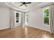 Bright bedroom with hardwood flooring, neutral paint, and large windows with backyard views at 2553 Creekwood Ter, Decatur, GA 30030