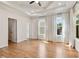 Bright bedroom featuring hardwood floors, tray ceiling, neutral walls, and natural light from the many windows at 2553 Creekwood Ter, Decatur, GA 30030