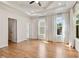Spacious bedroom features wood floors, a tray ceiling, recessed lighting, and large windows with white sheer curtains at 2553 Creekwood Ter, Decatur, GA 30030