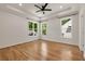 Spacious bedroom with hardwood floors, recessed lighting, fan, and three windows offering ample natural light at 2553 Creekwood Ter, Decatur, GA 30030
