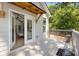 Covered porch features an open door to the living room with natural light, wood floors, and vaulted ceilings at 2553 Creekwood Ter, Decatur, GA 30030