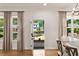 Bright dining area featuring hardwood floors, neutral curtains, and a view to the outdoors at 2553 Creekwood Ter, Decatur, GA 30030