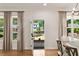Bright dining area with hardwood floors, modern light fixture, and backyard view at 2553 Creekwood Ter, Decatur, GA 30030