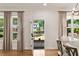 Sunlit dining area featuring hardwood floors and neutral-toned curtains at 2553 Creekwood Ter, Decatur, GA 30030