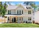 Charming two-story home with a landscaped front yard, covered porch, and neutral color scheme at 2553 Creekwood Ter, Decatur, GA 30030