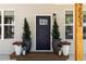 Inviting front entrance with elegant potted plants framing a dark, paneled door at 2553 Creekwood Ter, Decatur, GA 30030