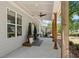 Inviting front porch with natural wood columns, ceiling fan, and charming decorative plants at 2553 Creekwood Ter, Decatur, GA 30030