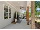 Charming covered porch with rustic wooden posts, ambient lighting and verdant foliage at 2553 Creekwood Ter, Decatur, GA 30030