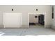 Spacious three car garage featuring built-in cabinets, black rubber flooring, and overhead lighting at 2553 Creekwood Ter, Decatur, GA 30030