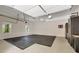 Open garage with rubber flooring and built in black cabinets for storage, with natural light from the windows at 2553 Creekwood Ter, Decatur, GA 30030