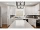 Bright kitchen boasts white cabinets, marble countertops, an island, and stainless steel appliances at 2553 Creekwood Ter, Decatur, GA 30030