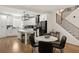 Modern kitchen next to dining room boasts white cabinets, island with seating at 2553 Creekwood Ter, Decatur, GA 30030