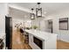 Open-concept kitchen with white cabinets, island with seating, and modern appliances at 2553 Creekwood Ter, Decatur, GA 30030